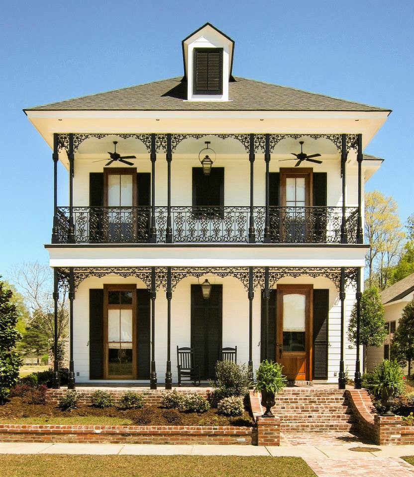 Lanky Wrought Iron Columns Add A Pleasant Look To The Porch Of A Two Story House 